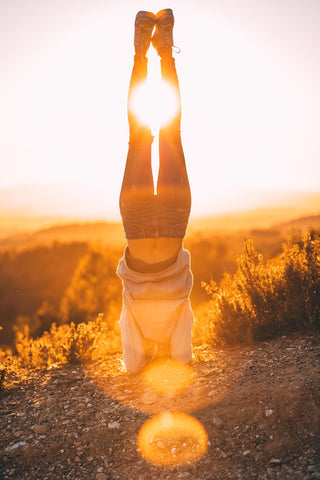 A yogi in headstand outdoors