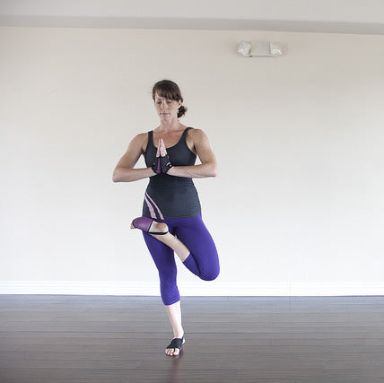 Yogi practicing Tree Pose on a non-slip yoga mat